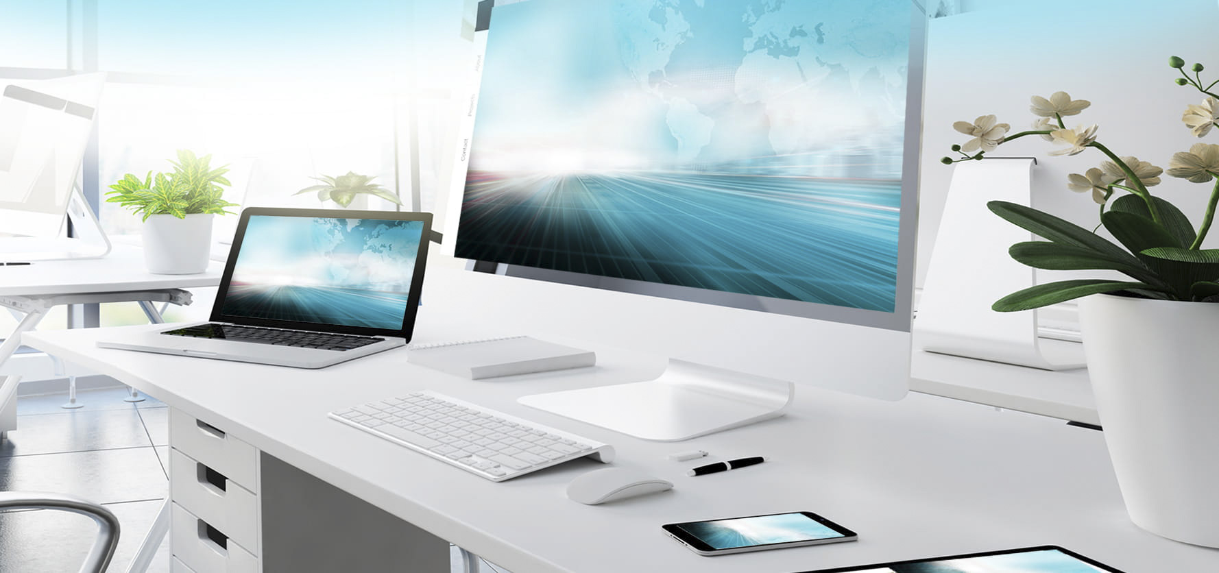 Modern white office desk with large monitor, laptop, keyboard, mouse, smartphone, and potted plants in a bright workspace
